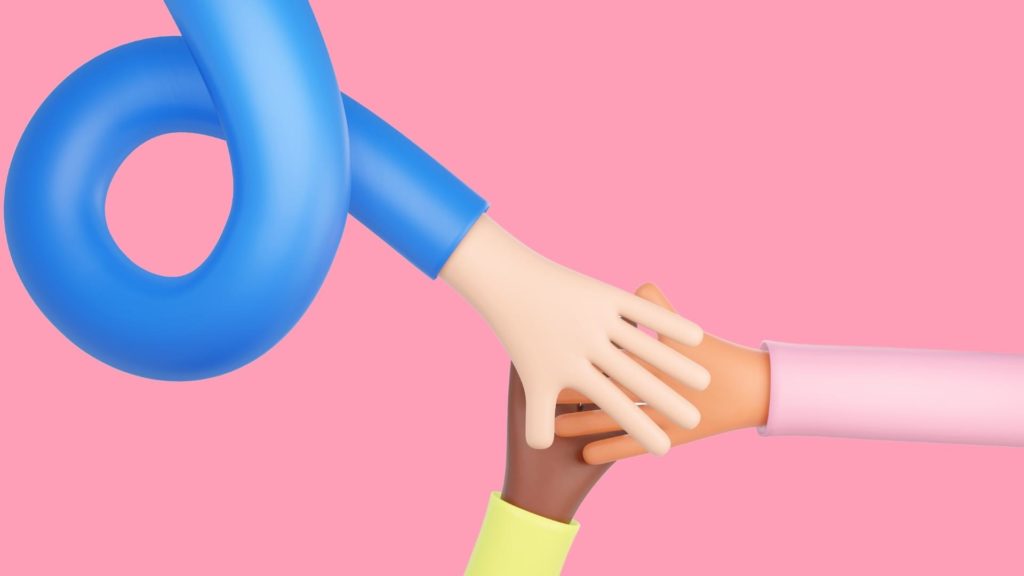 People joining hands during an activity in hybrid event